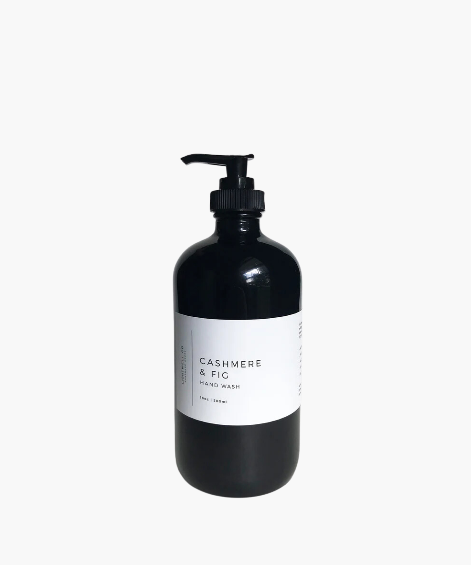 A sleek black bottle with a pump dispenser labeled "Cashmere & Fig Hand Wash." Minimalist design conveys elegance and a sense of luxury.