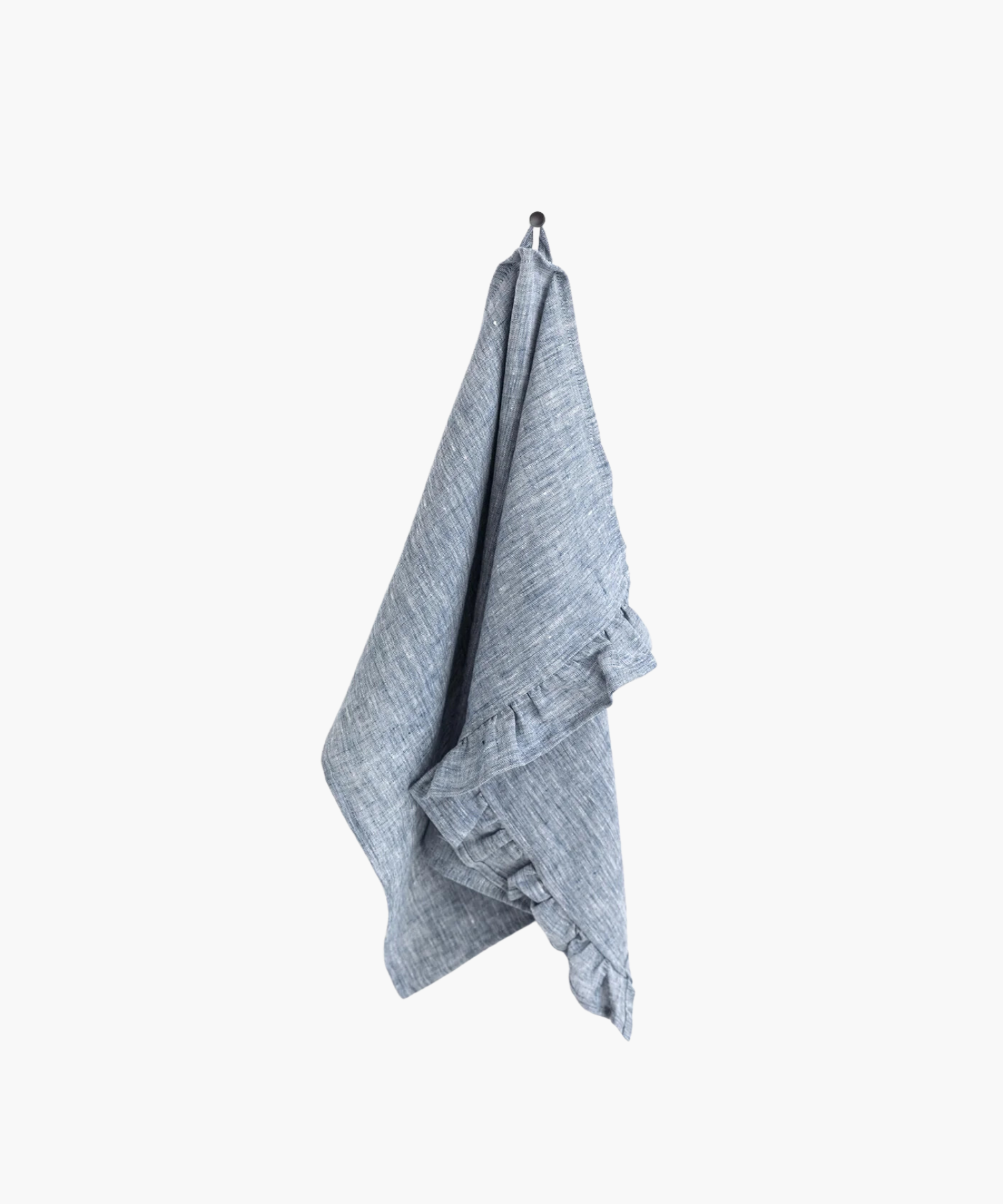 A blue linen tea towel with ruffle trim hangs neatly on a black hook against a plain white background, creating a clean and minimalistic appearance.