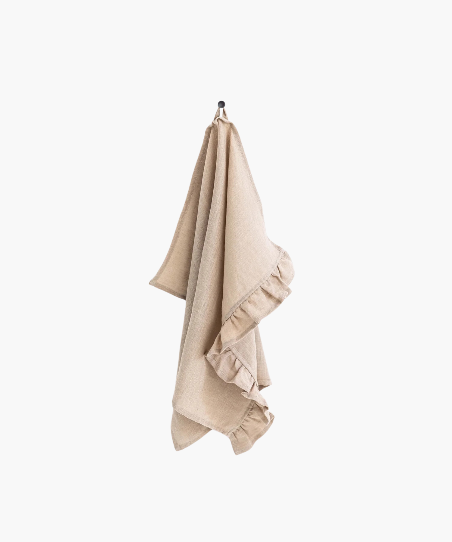 A beige linen tea towel with ruffle trim hangs neatly on a black hook against a plain white background, creating a clean and minimalistic appearance.