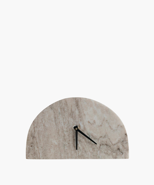 A minimalist clock with a half-circle marble face and sleek black hands. The marble has natural, soft gray and tan patterns, conveying elegance and simplicity.