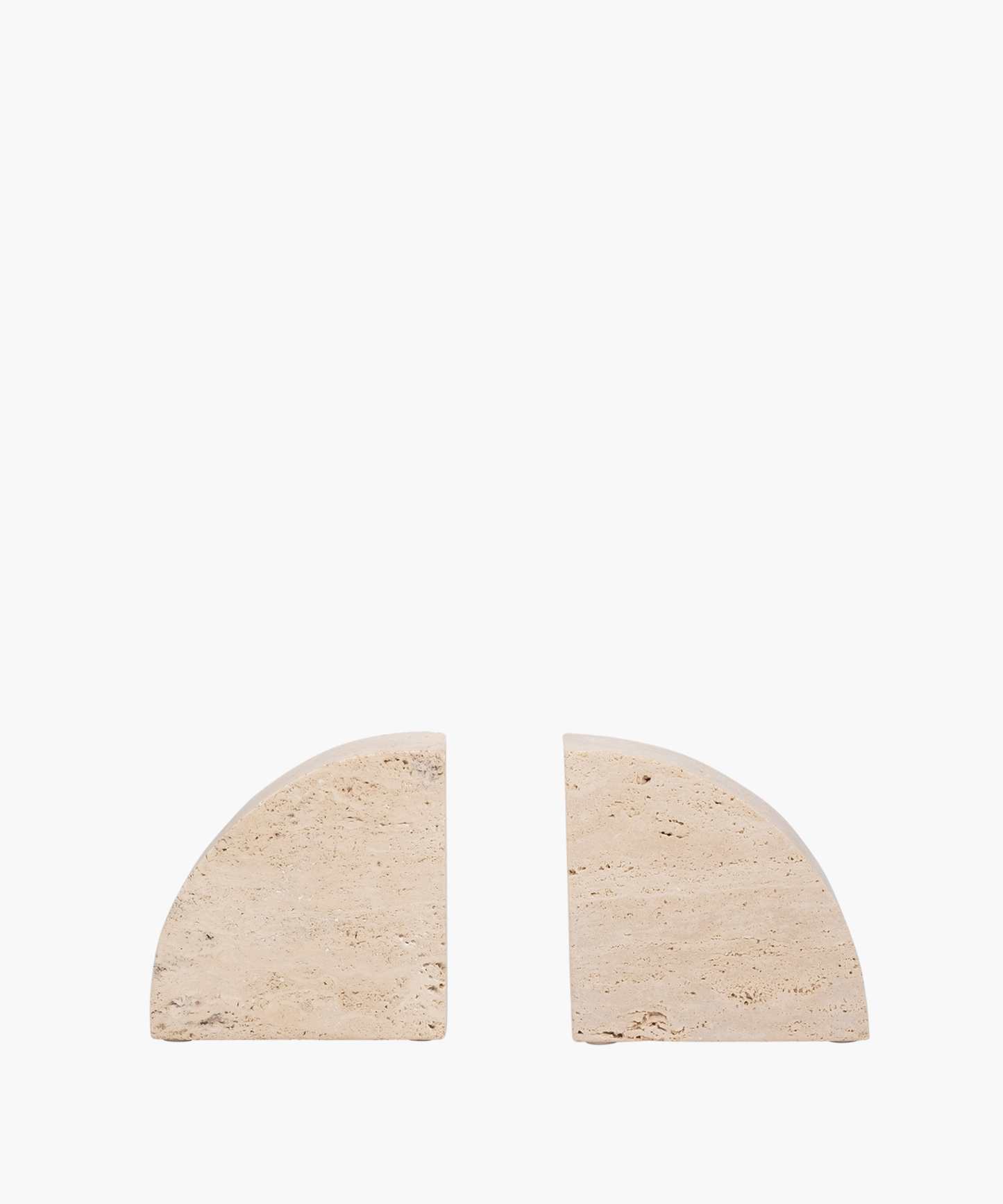 Two beige, semi-circular travertine bookends with textured surfaces are placed against a white background, separated by a small gap, creating a minimalist design.